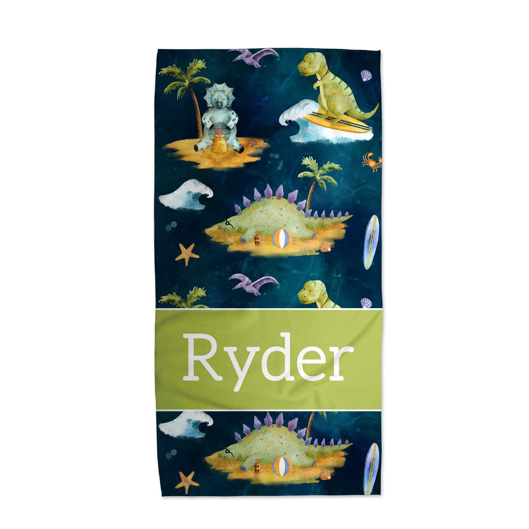 Personalized kids beach towel with surfing dinosaurs and palm trees design, name Ryder on green band