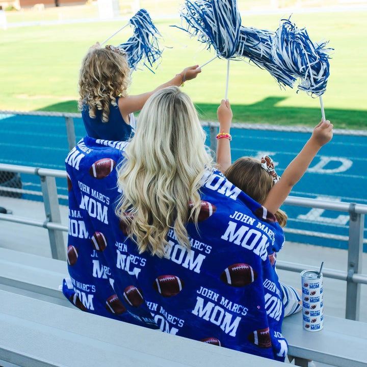 Personalized blue and white team spirit bleacher blanket with child's name on it. 