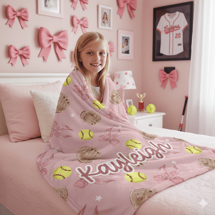 Pink Softball Coquette Bow Blanket wrapped around a little girl.
