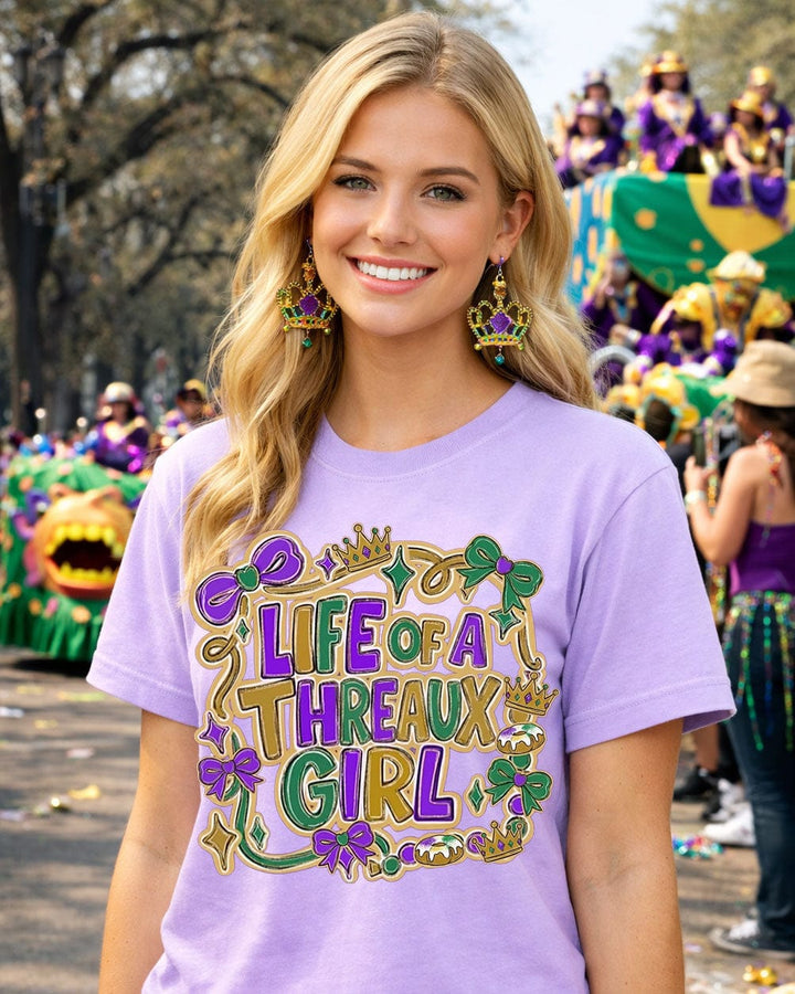 Woman wearing a purple t-shirt with 'Life of a Threaux Girl' design at a Mardi Gras parade